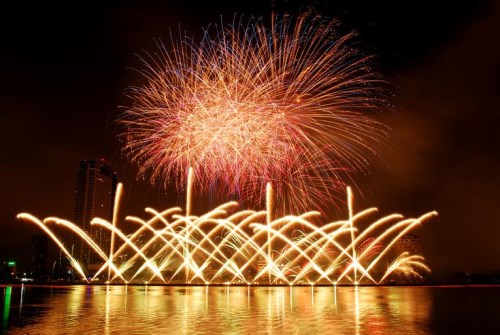 fireworks with water in the foreground